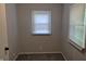 Compact bedroom with plush carpeting, natural lighting from a large window, and neutral paint at 1584 Shady Ln, Columbus, IN 47201