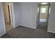 Cozy bedroom featuring plush carpeting, neutral walls, and doorways to the bathroom and another room at 1584 Shady Ln, Columbus, IN 47201