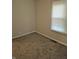 Cozy bedroom featuring plush carpeting and natural light from a window and neutral paint at 1584 Shady Ln, Columbus, IN 47201