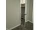 A view into a bedroom closet showing wire shelving, and carpeted floor at 1584 Shady Ln, Columbus, IN 47201