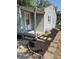 View of the front entrance with a storm door, brick steps, and new landscaping at 1584 Shady Ln, Columbus, IN 47201