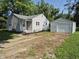 Charming single-story home with a detached garage and driveway at 1584 Shady Ln, Columbus, IN 47201