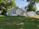 Single-story home with a detached garage and large lawn at 1584 Shady Ln, Columbus, IN 47201