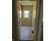 Laundry room with tiled flooring, washer/dryer hookups, and view from open doorway at 1584 Shady Ln, Columbus, IN 47201