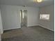 Inviting living room with plush carpeting, neutral walls, and open view to kitchen and other rooms at 1584 Shady Ln, Columbus, IN 47201