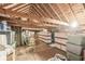 Spacious attic area featuring exposed wood beams, ample storage, and natural light at 1621 Beeler Ave, Speedway, IN 46224
