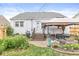 A backyard featuring a hot tub under a canopy, surrounded by brick patio and lush greenery at 1621 Beeler Ave, Speedway, IN 46224