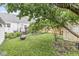 Expansive backyard with a patio, lush lawn, and mature trees offers a serene outdoor experience at 1621 Beeler Ave, Speedway, IN 46224
