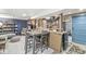 Cozy basement area featuring a dining table, bar, shelving, and exposed utilities at 1621 Beeler Ave, Speedway, IN 46224