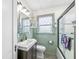 Charming bathroom featuring a sink vanity, updated shower, and natural light from the window at 1621 Beeler Ave, Speedway, IN 46224