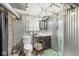 Industrial-style bathroom featuring a shower, sink, toilet, and corrugated metal walls at 1621 Beeler Ave, Speedway, IN 46224