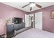 Bedroom with a ceiling fan, plum colored walls, and tv on a cabinet at 1621 Beeler Ave, Speedway, IN 46224