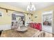 Cozy dining room featuring wood table, red drawer set, and archway to a bright living area at 1621 Beeler Ave, Speedway, IN 46224