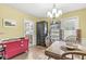 Bright dining room featuring hardwood floors, a chandelier, and ample natural light at 1621 Beeler Ave, Speedway, IN 46224