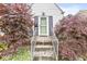 Inviting entrance with a decorative glass door framed by lush, mature landscaping at 1621 Beeler Ave, Speedway, IN 46224