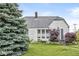 Charming two-story home with a well-maintained lawn, blue spruce, and colorful garden bed at 1621 Beeler Ave, Speedway, IN 46224