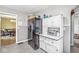 Quaint kitchen with black fridge, vintage cabinets, patterned flooring, and view to a breakfast nook at 1621 Beeler Ave, Speedway, IN 46224