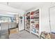Cozy living room with white shelving units for storage solutions near an entrance way and carpet flooring at 1621 Beeler Ave, Speedway, IN 46224