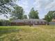 The backyard features a well-maintained lawn and an elegant brick exterior at 1628 Edgewood Dr, Anderson, IN 46011