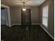 Dining room with dark floors, neutral walls, and a modern light fixture above the table at 1628 Edgewood Dr, Anderson, IN 46011