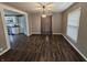 Dining room with dark floors, neutral walls, view into adjacent kitchen, and a modern light at 1628 Edgewood Dr, Anderson, IN 46011