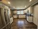 Updated kitchen boasts stainless steel appliances, granite countertops, and ample cabinet space at 1628 Edgewood Dr, Anderson, IN 46011