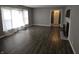 Empty living room with modern flooring, a fireplace, and soft natural light from the window at 1628 Edgewood Dr, Anderson, IN 46011