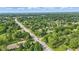 Scenic aerial view of homes nestled amongst mature trees, conveniently located along a well-maintained road at 17 E Beechwood Ln, Indianapolis, IN 46227