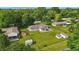 Aerial view showcasing a home with a spacious yard, storage sheds, and proximity to mature trees at 17 E Beechwood Ln, Indianapolis, IN 46227