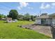Spacious backyard with lush green grass, storage sheds, and a charming stone patio area at 17 E Beechwood Ln, Indianapolis, IN 46227