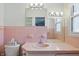A bathroom featuring bright lighting and pink tiling at 17 E Beechwood Ln, Indianapolis, IN 46227
