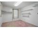 A spacious bedroom with shelving, large window and bright lighting at 17 E Beechwood Ln, Indianapolis, IN 46227