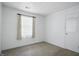 An empty bedroom with carpet, white walls, and a window with curtains at 17 E Beechwood Ln, Indianapolis, IN 46227