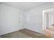 An empty bedroom with carpet, white walls, and a door at 17 E Beechwood Ln, Indianapolis, IN 46227