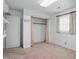 A bedroom featuring a spacious closet, built-in shelving, and a neutral-toned carpet at 17 E Beechwood Ln, Indianapolis, IN 46227
