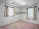 Bright bedroom featuring two windows, built-in shelving, neutral paint and a neutral carpet at 17 E Beechwood Ln, Indianapolis, IN 46227