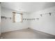 An empty room with neutral paint, neutral carpeting, and a large window at 17 E Beechwood Ln, Indianapolis, IN 46227