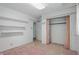 A spacious room with built-in shelving and a closet at 17 E Beechwood Ln, Indianapolis, IN 46227
