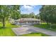 Charming single-story home with a well-manicured lawn, mature trees, and an American flag displayed at 17 E Beechwood Ln, Indianapolis, IN 46227
