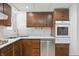 This kitchen features wood cabinets, stainless steel appliances, and white tile backsplash at 17 E Beechwood Ln, Indianapolis, IN 46227