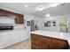 A kitchen with white cabinets, stainless steel appliances, and a center island with dark wood cabinets at 17 E Beechwood Ln, Indianapolis, IN 46227