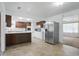 Eat-in kitchen featuring a stainless steel refrigerator, an island, and modern lighting at 17 E Beechwood Ln, Indianapolis, IN 46227