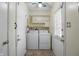 A well-lit laundry room featuring cabinets, a utility sink, and modern washer and dryer at 17 E Beechwood Ln, Indianapolis, IN 46227