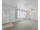 View of the well-lit living room featuring neutral carpet, white walls, and a ceiling fan at 17 E Beechwood Ln, Indianapolis, IN 46227