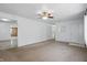 Spacious living room featuring neutral carpet, white walls, a ceiling fan, and closet at 17 E Beechwood Ln, Indianapolis, IN 46227