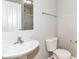Clean bathroom features a pedestal sink, toilet, and framed mirror with shower at 174 Straughn Ln, Westfield, IN 46074