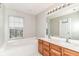 Bright bathroom features a soaking tub, double sink vanity, and a large mirror at 174 Straughn Ln, Westfield, IN 46074