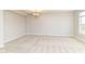 Spacious bedroom offering a neutral color scheme, soft carpet, and a modern chandelier at 174 Straughn Ln, Westfield, IN 46074