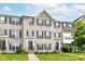Charming brick townhome featuring manicured lawn, symmetrical design and inviting front entrances at 174 Straughn Ln, Westfield, IN 46074