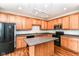 Open kitchen boasts a center island, plenty of cabinet space, and modern black appliances at 174 Straughn Ln, Westfield, IN 46074